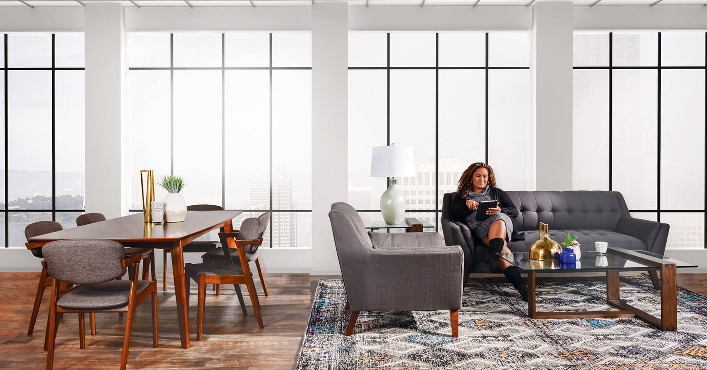 Hard wood floors with a dining table and sofa next to each other. 