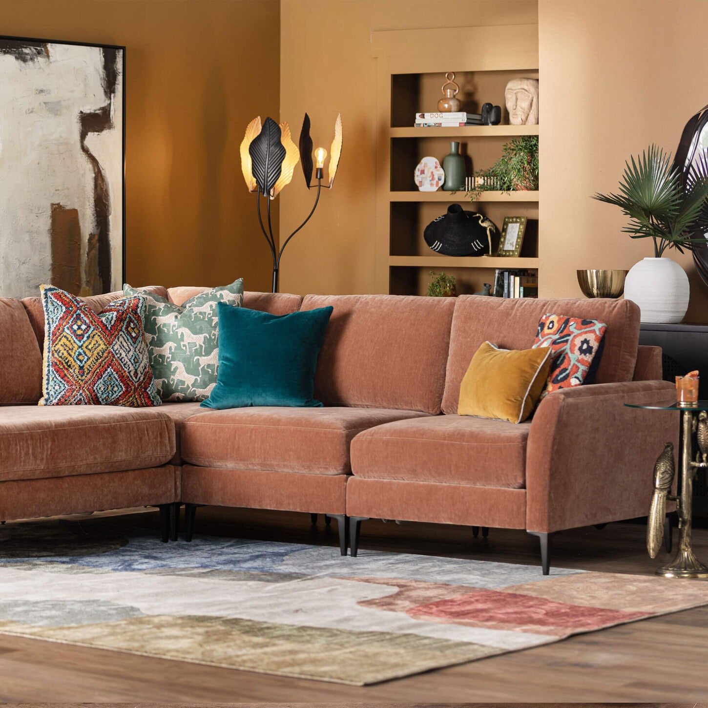 Orange sectional in living room with brown walls