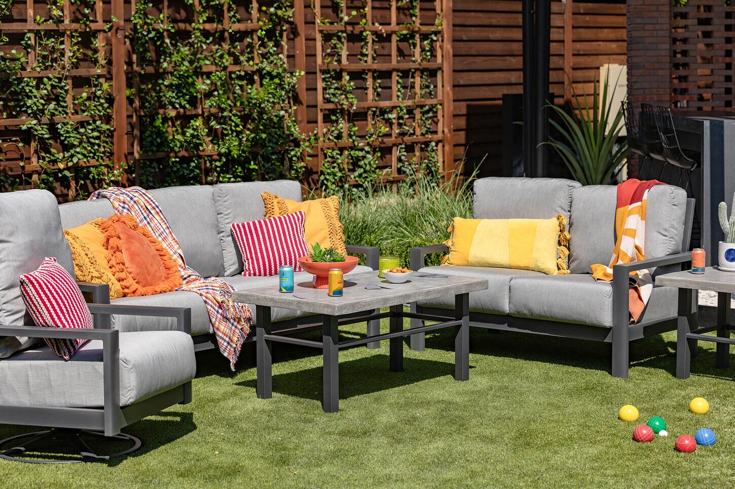 Gray outdoor seating area with yellow, orange, and red accents.