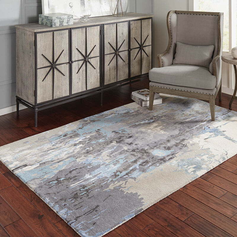distressed wood side board next to a tan and beige arm chair on top of a multicolored area rug