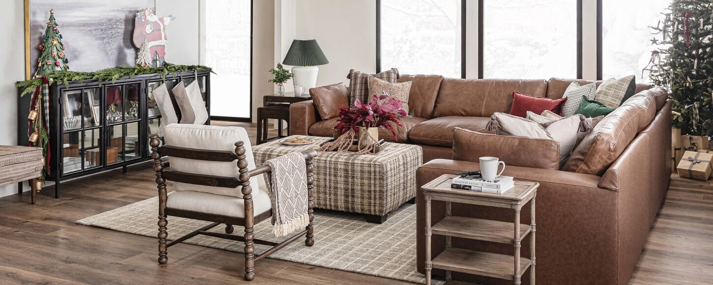 Christmas-decorated living room with snow falling outside