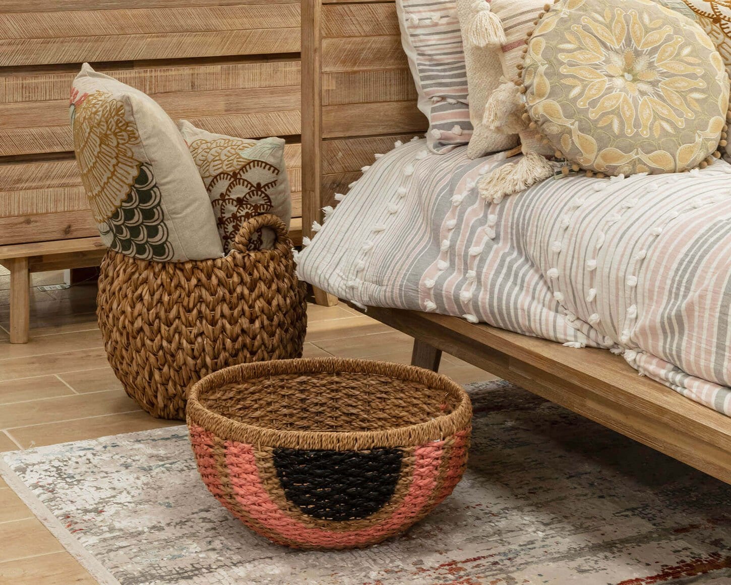 Rug in bedroom with baskets of blankets and pillows