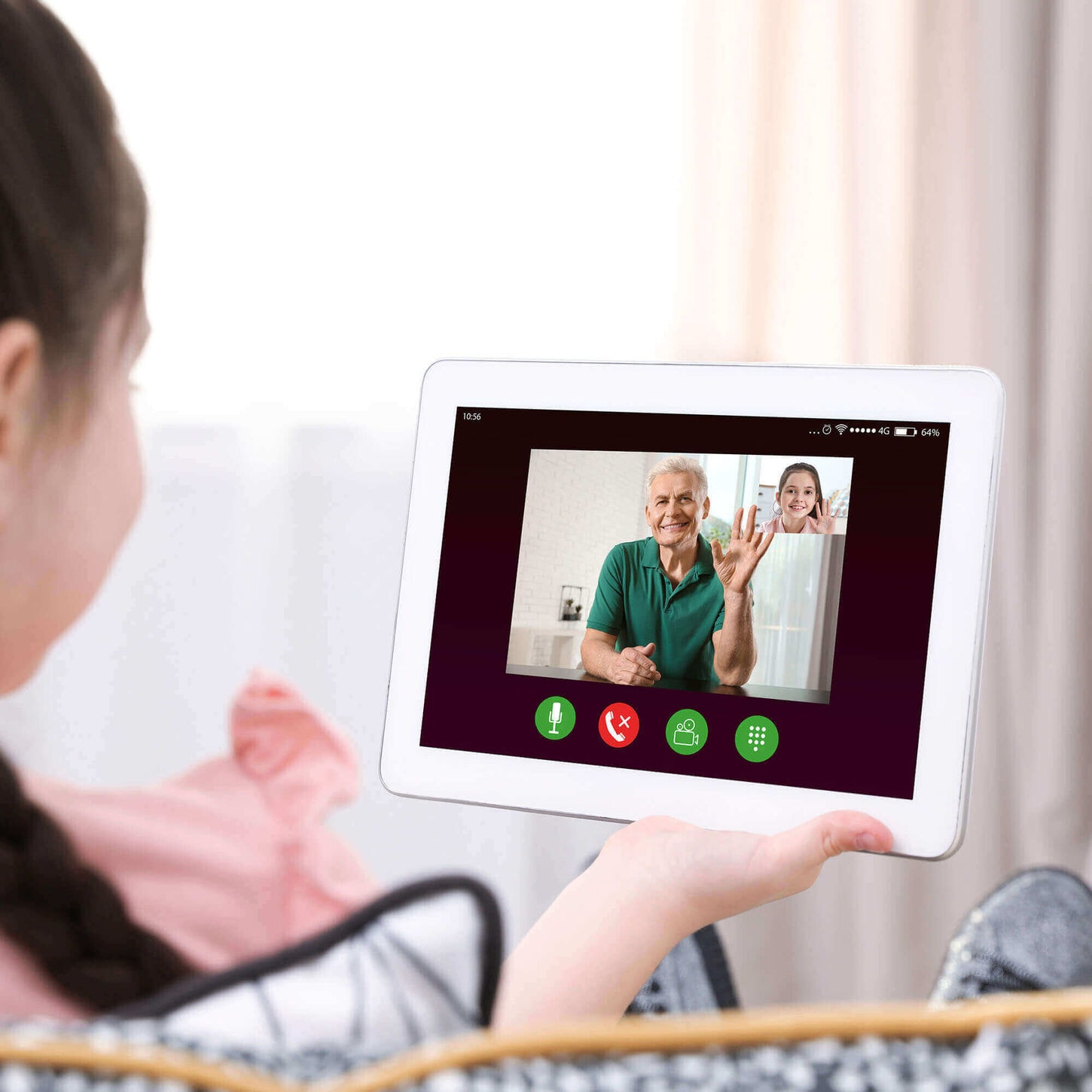 Young girl holding a smart home product facetiming her grandparents