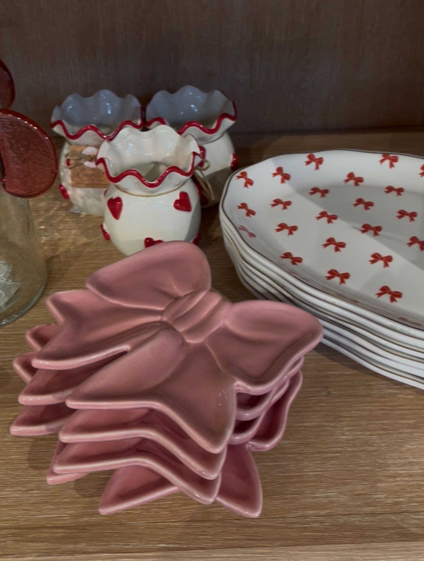 Valentine's plates featuring a pink bow, red and white bows, and bowls