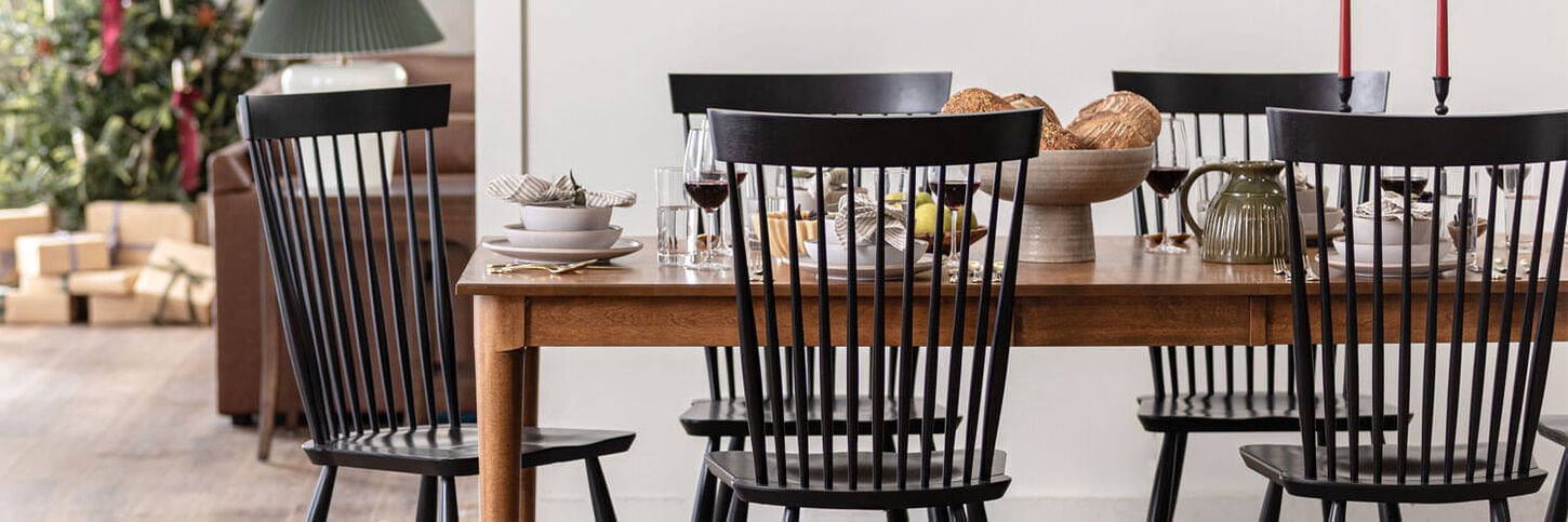 Holiday table setting with christmas tree in background
