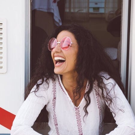 Woman wearing pink lensed sunglasses