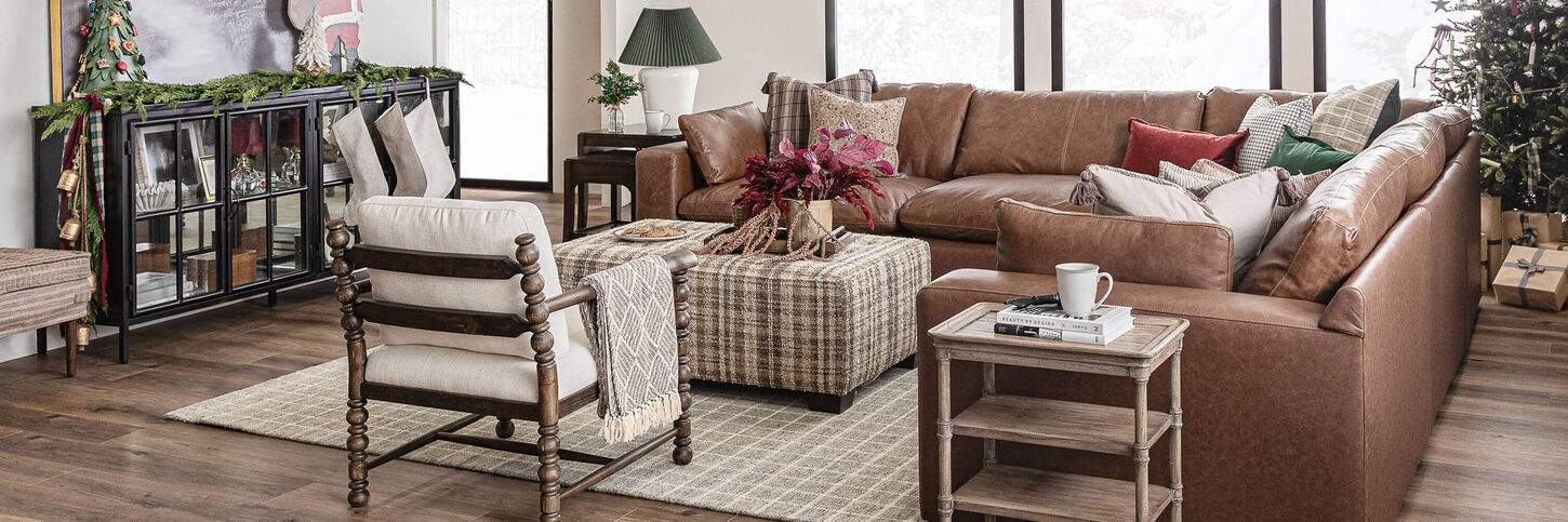Christmas-decorated living room with snow falling outside