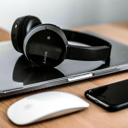 Laptop, smartphone and other devices laid on table