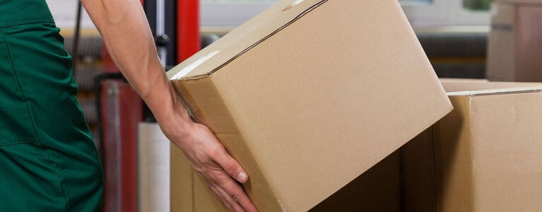 NFM Warehouse worker lifting up a box