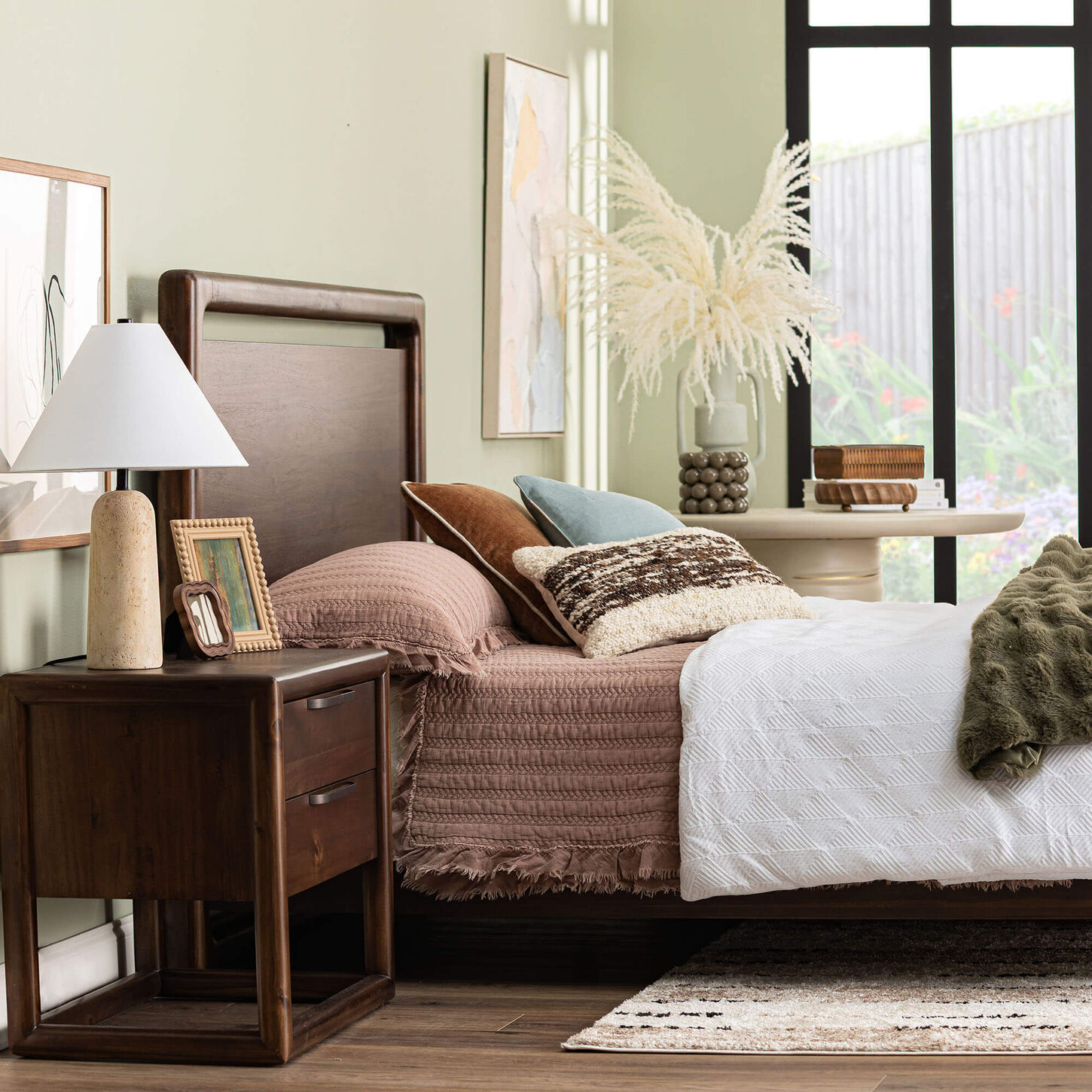 bright bedroom with dark wood bed and nightstand