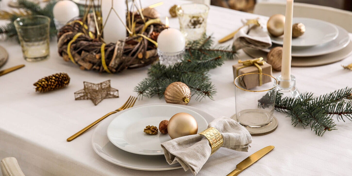 white place setting on a holiday themed dining room table