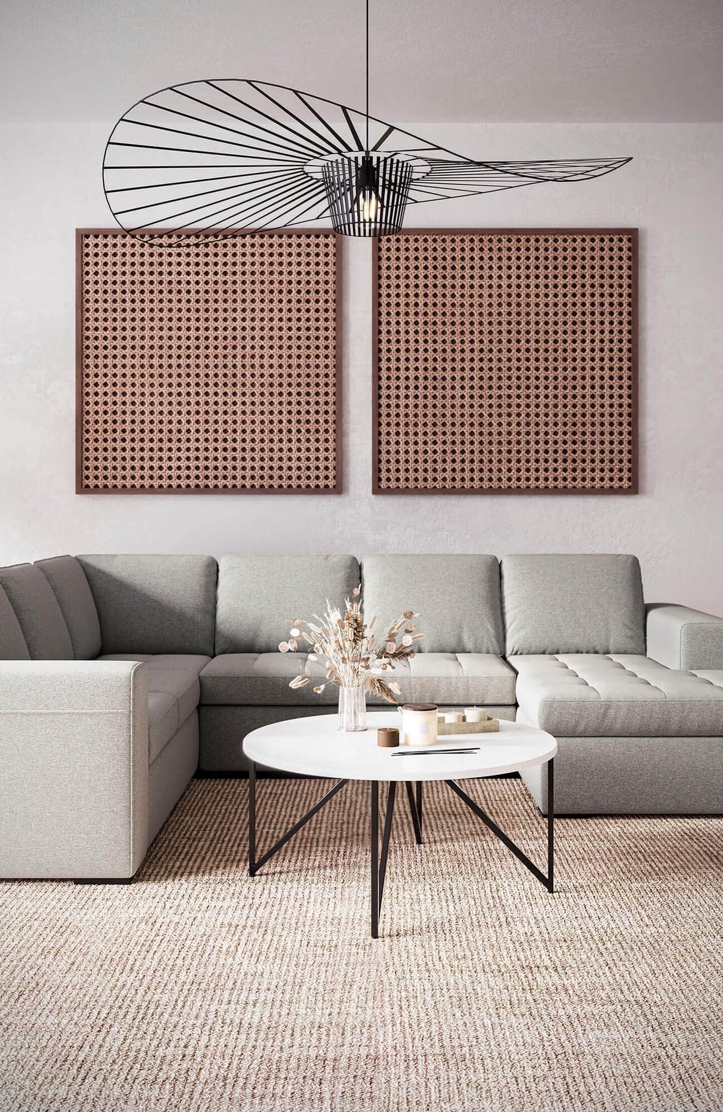 A living room with 2 big paintings and an industrial fan above the couch