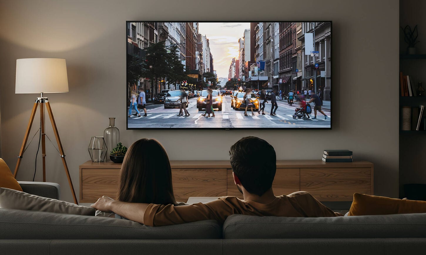 Couple watching a movie on their couch in a dim room