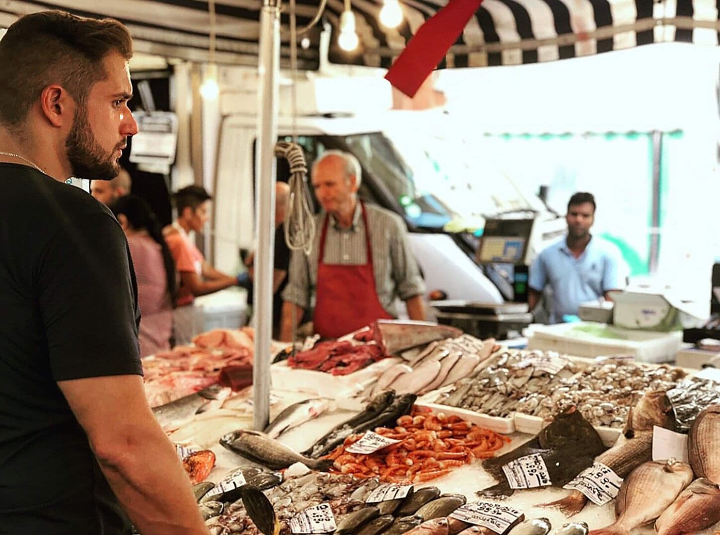 Preston Paine scoping out a food market with fresh fish and seafood.