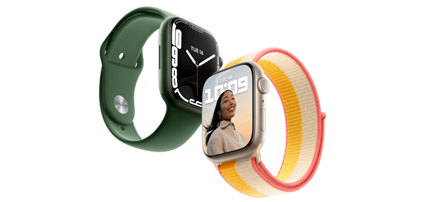 One green Apple Watch and one starlight Apple Watch overlapping