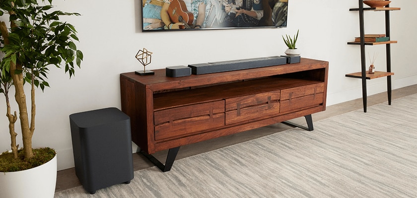 JBL Soundbar and subwoofer on a midcentury modern TV stand