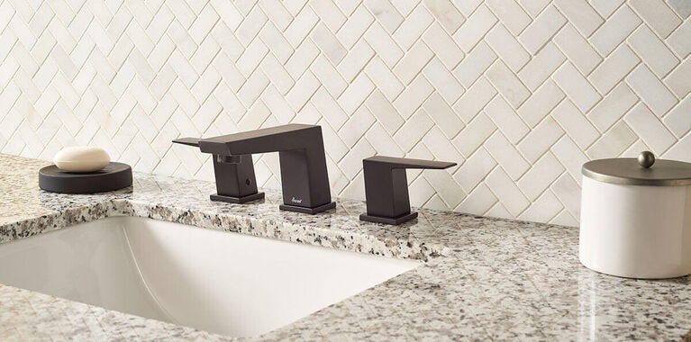 Granite countertop in bathroom with dark bronze faucet