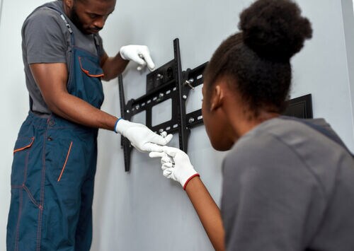 Salesperson and customer looking at gas ranges