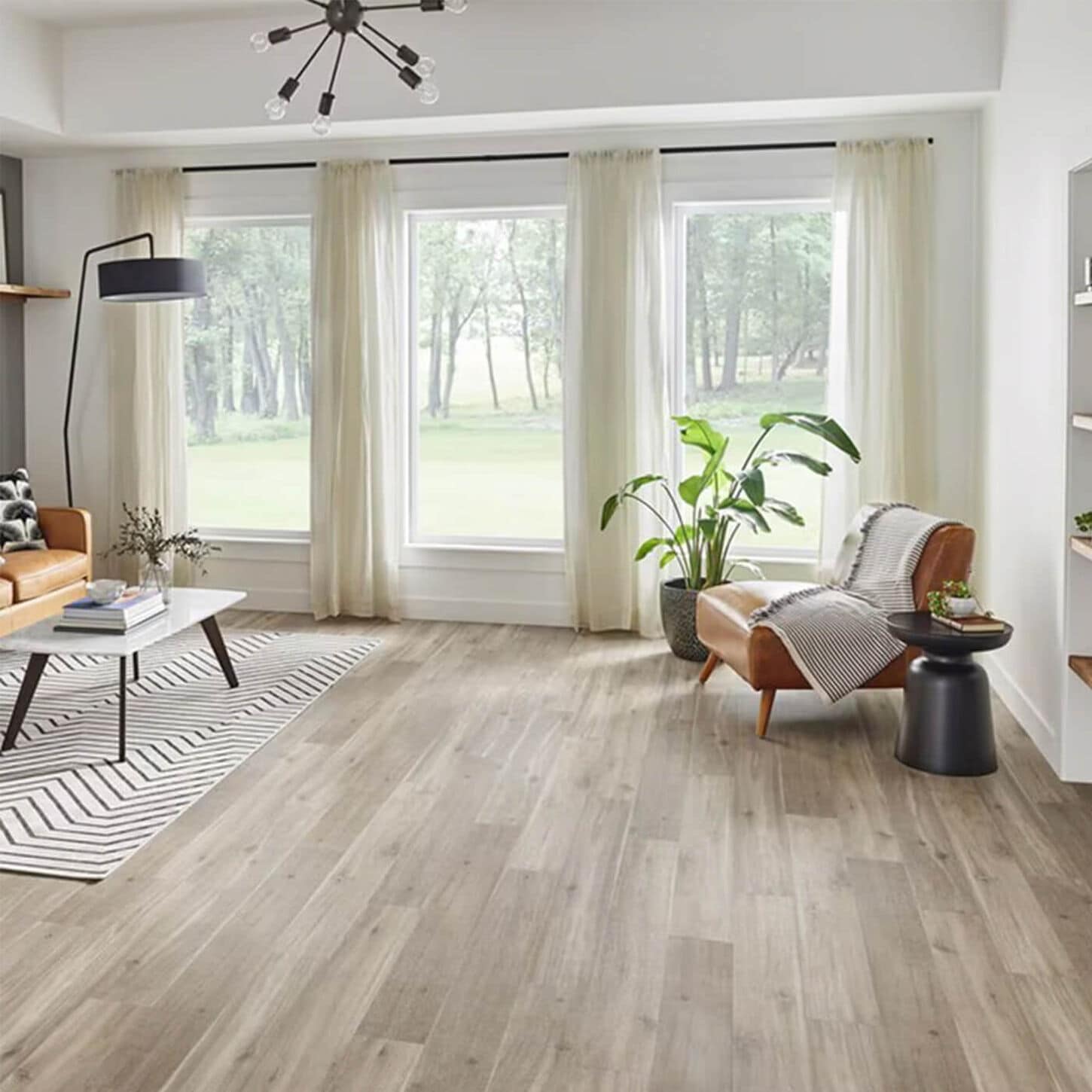 room setting with tan chair and wood table on a light wood grain floor