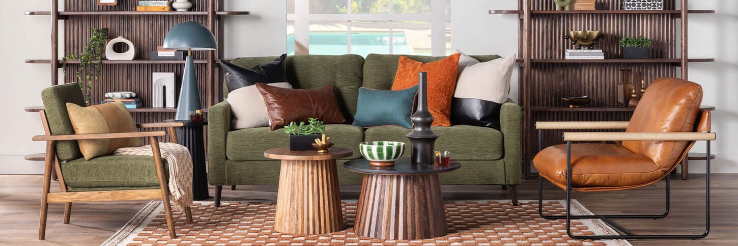 Brightly lit living room with green sofa and chairs