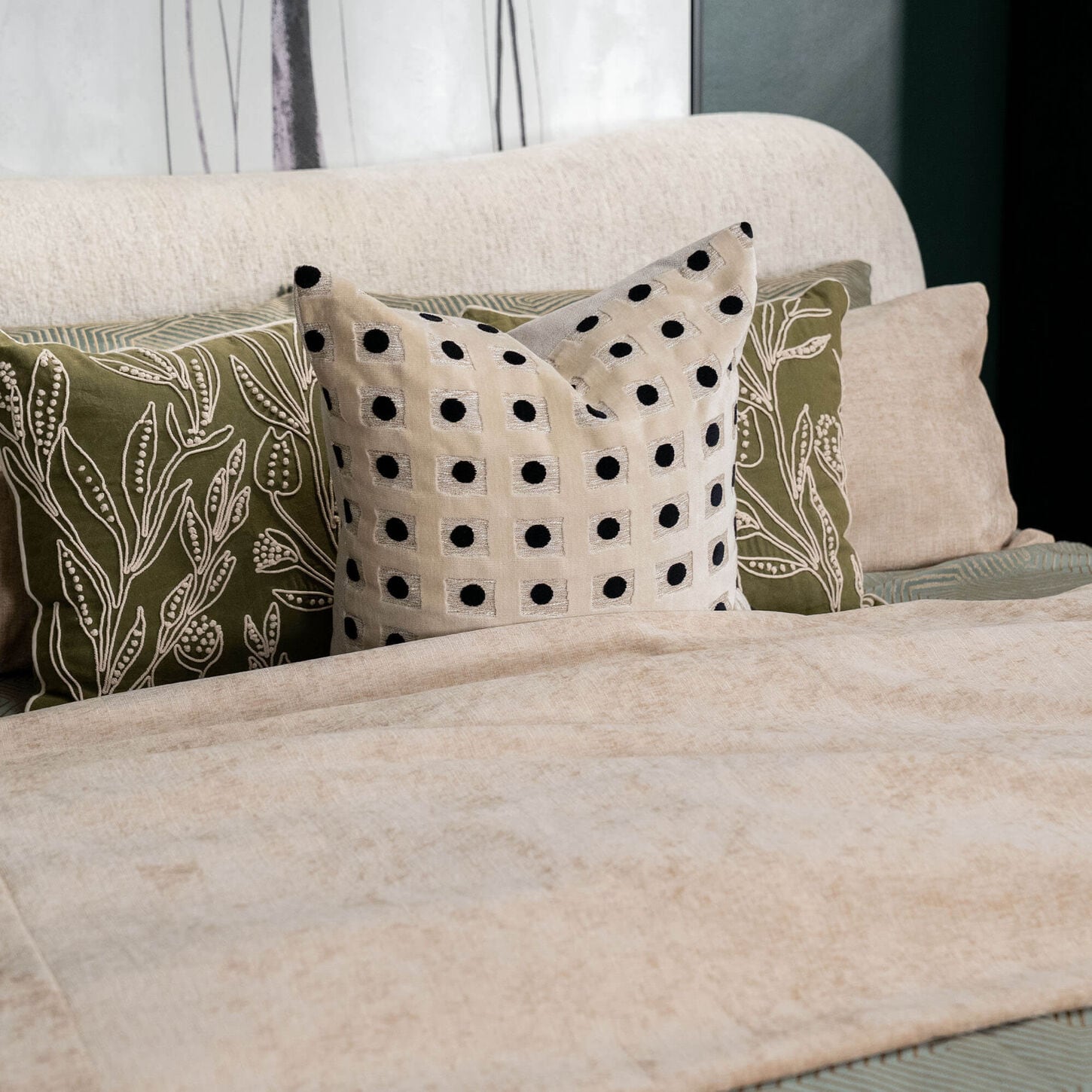 Green and white throw pillows on a bed