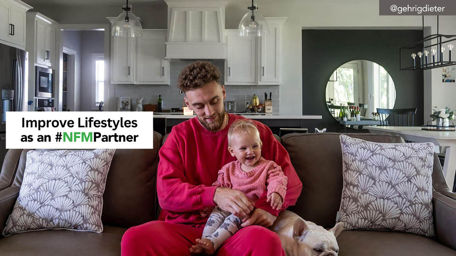 gerrick sitting on couch with child and dog