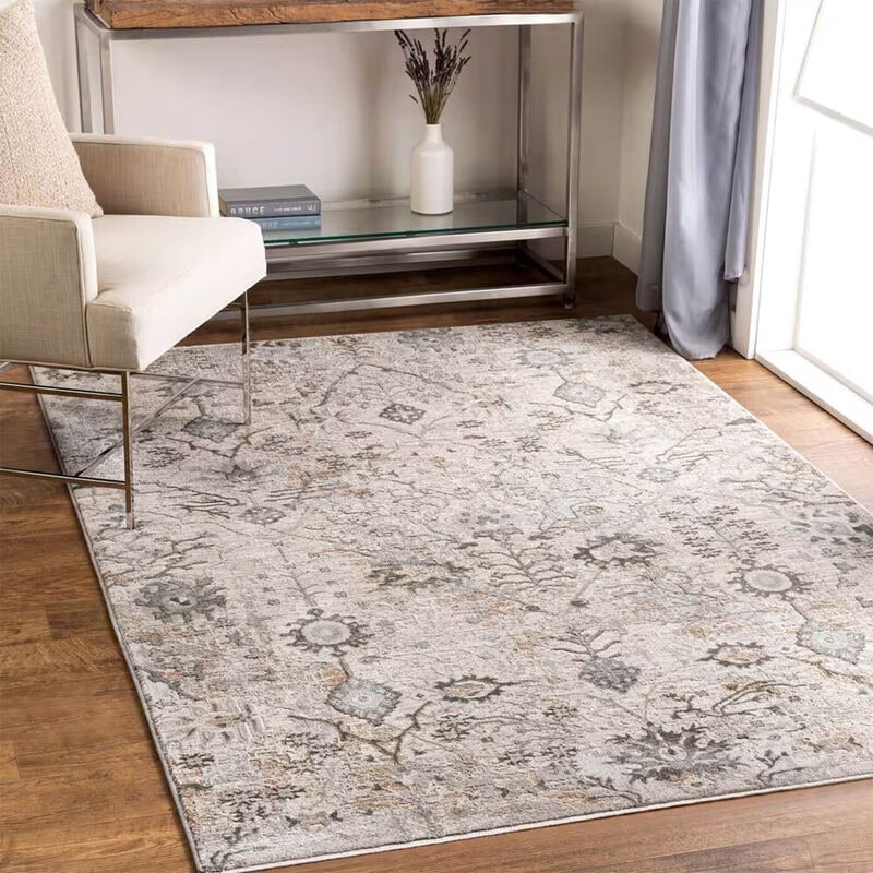 living room with white arm chair a silver shelf with an ivory area rug