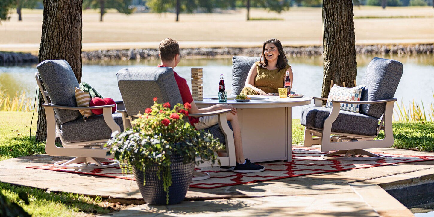 Couple sitting near a firepit in the backyard with flowers
