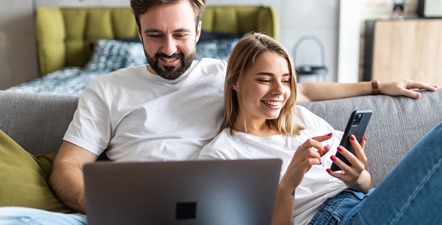 A couple using their laptop computer with confidence