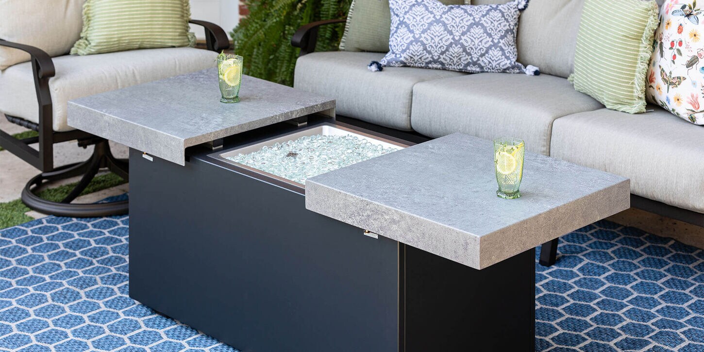 Outdoor patio furniture with a rug, chair, sofa, and a firepit