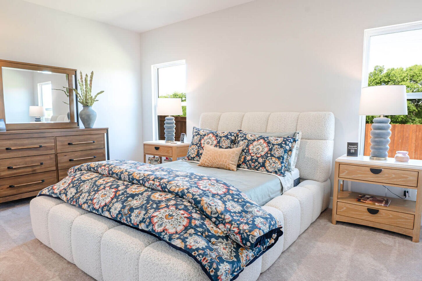 Bedroom with king size bed, dresser and two nightstand with lamps