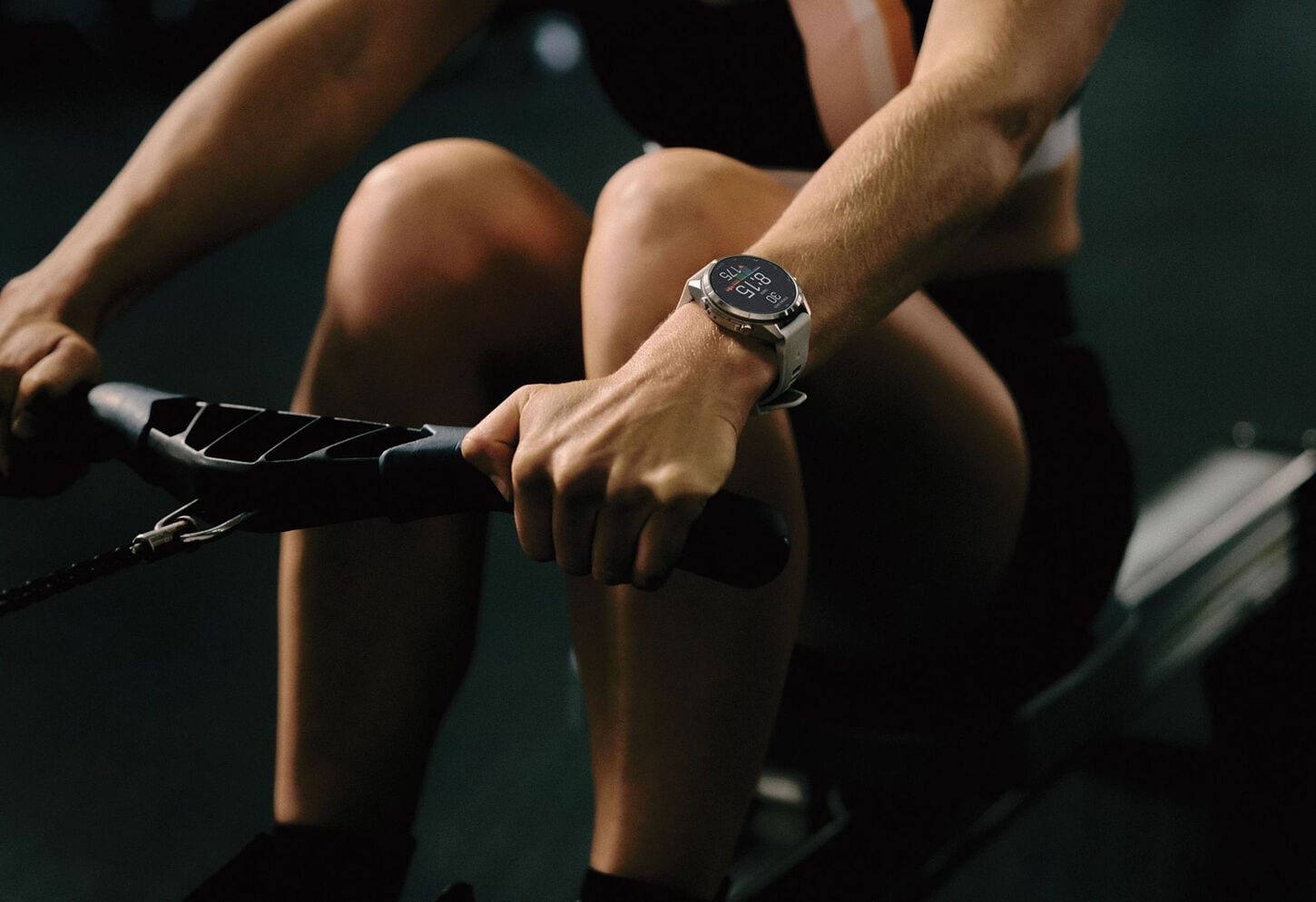 Woman on row machine wearing a Garmin fenix 9 watch