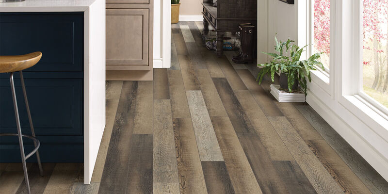 kitchen with black barstool and a woodgrain hard surface floor 