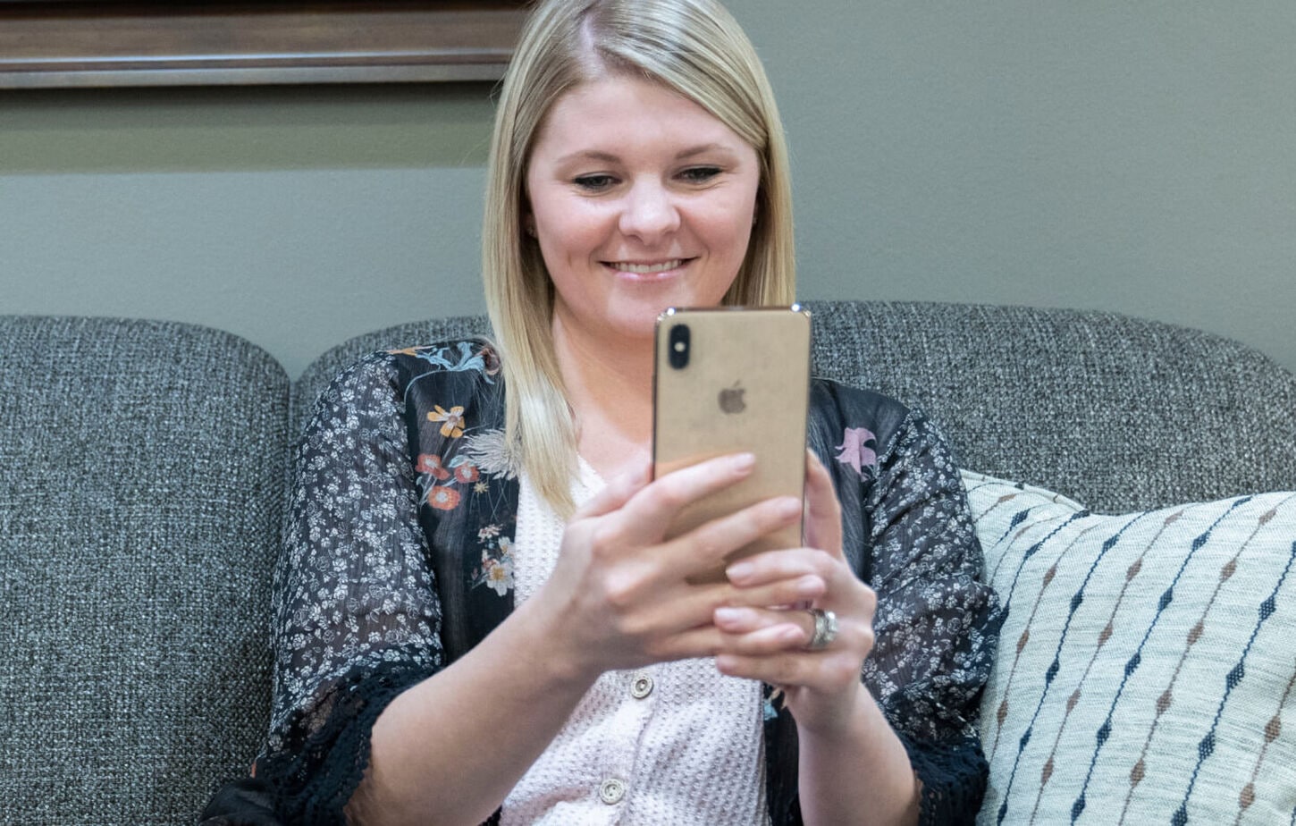 A woman smiling while she chats with a sales person