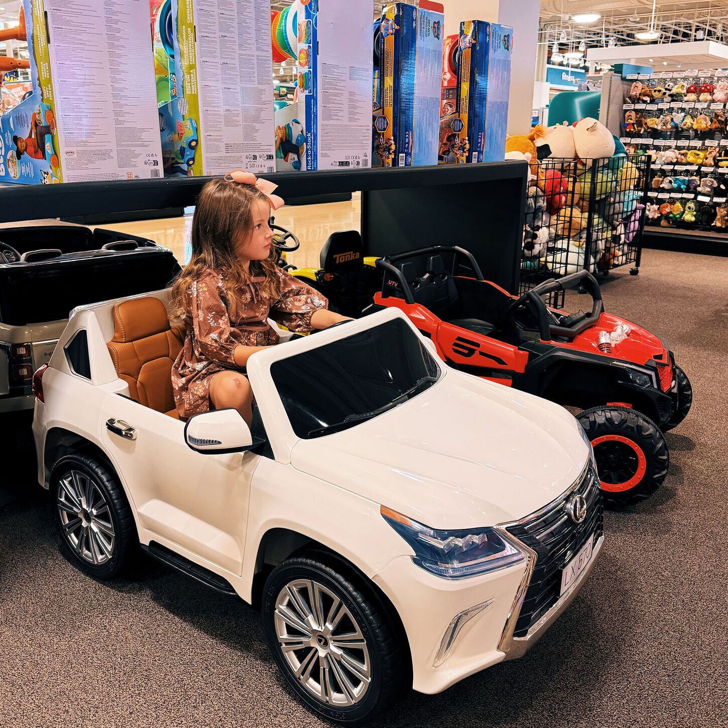 Hannah in kid's car at NFM shopping for gift guide for kids