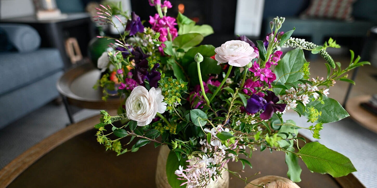 Beautiful and vibrant flowers in a vase for a wedding sitting on a table