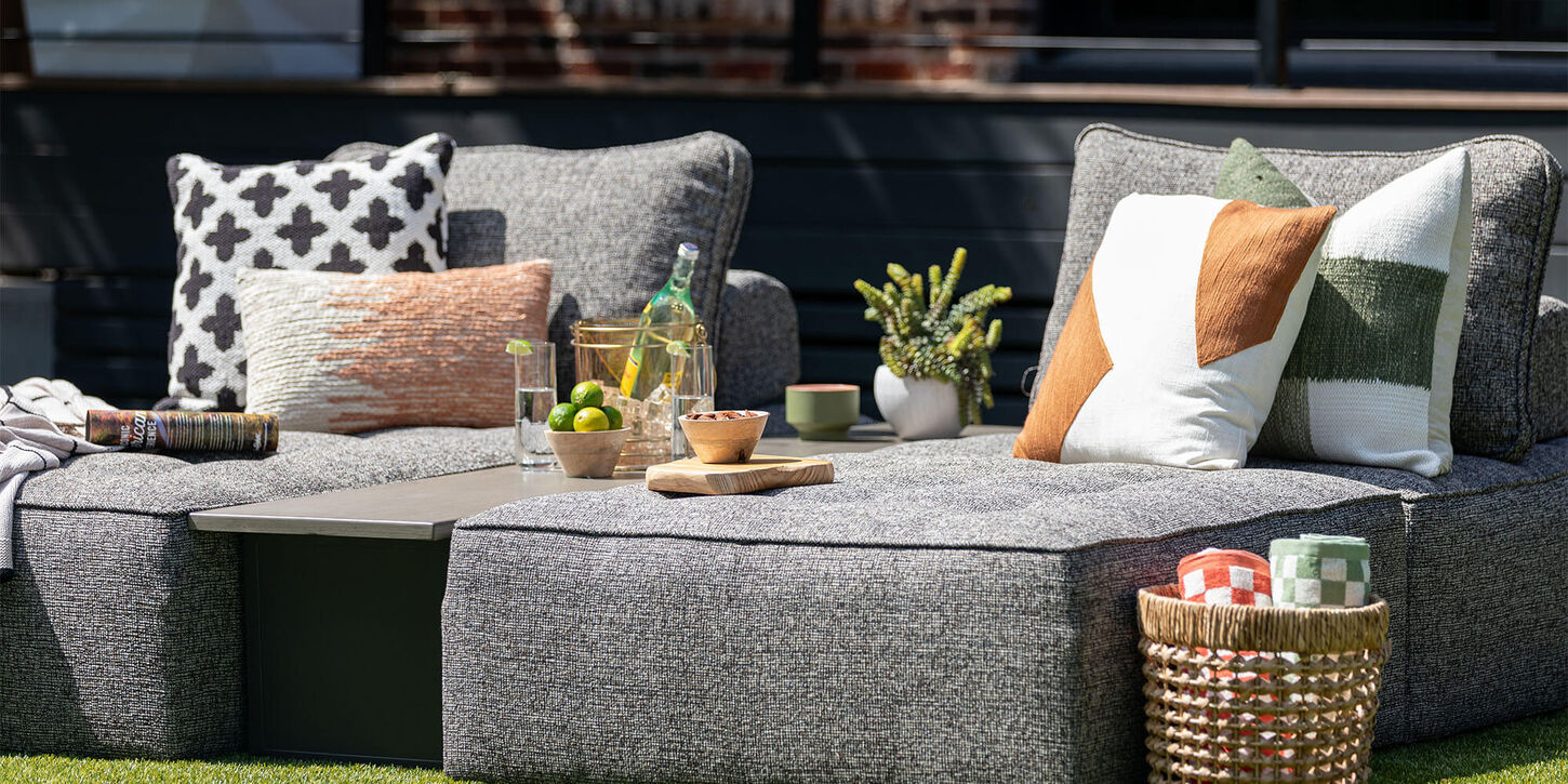 Outdoor furniture with throw pillows and drinks