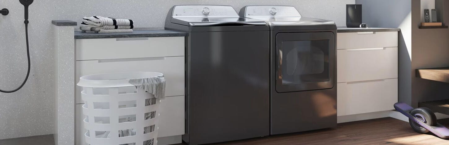 Laundry pair in between white cabinets in a laundry room