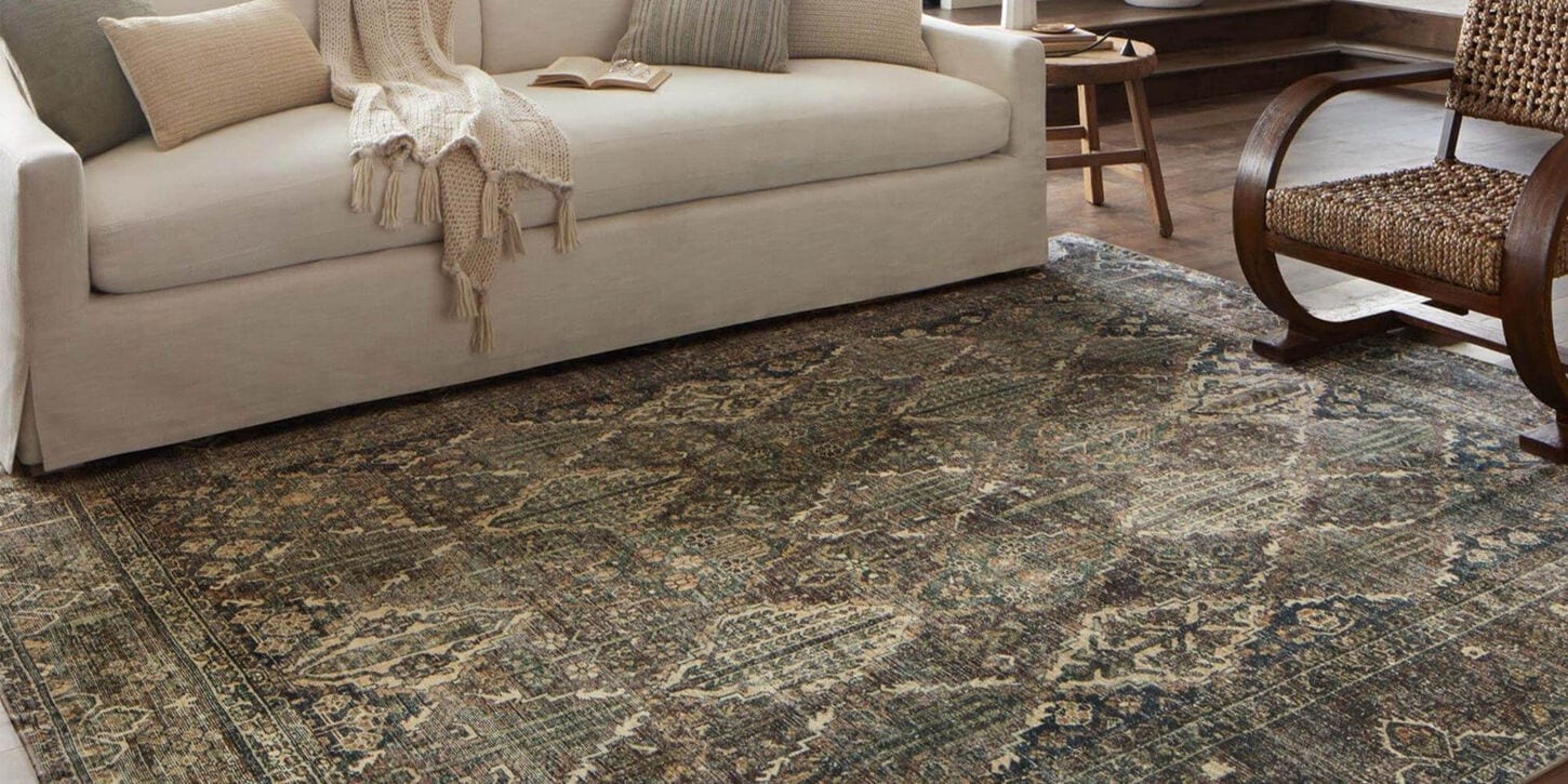 loloi area rug with beige sofa and dark wood chair