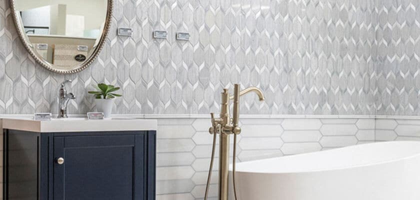 Bathroom with vanity, bathtub, and tiled walls