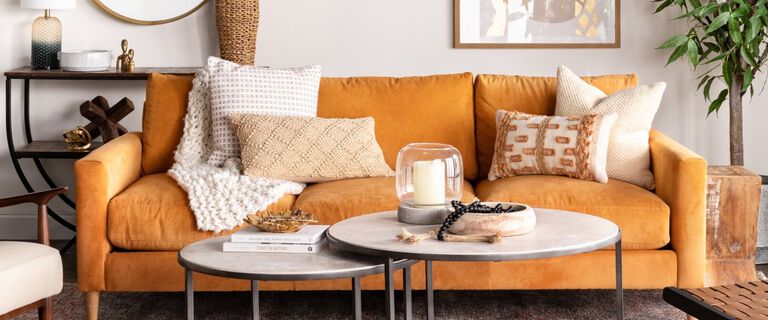 Living Room with Gold Couch, Wooden Chair, and Granite Coffee Table