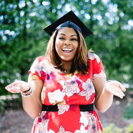 Student graduating smiling with cap on