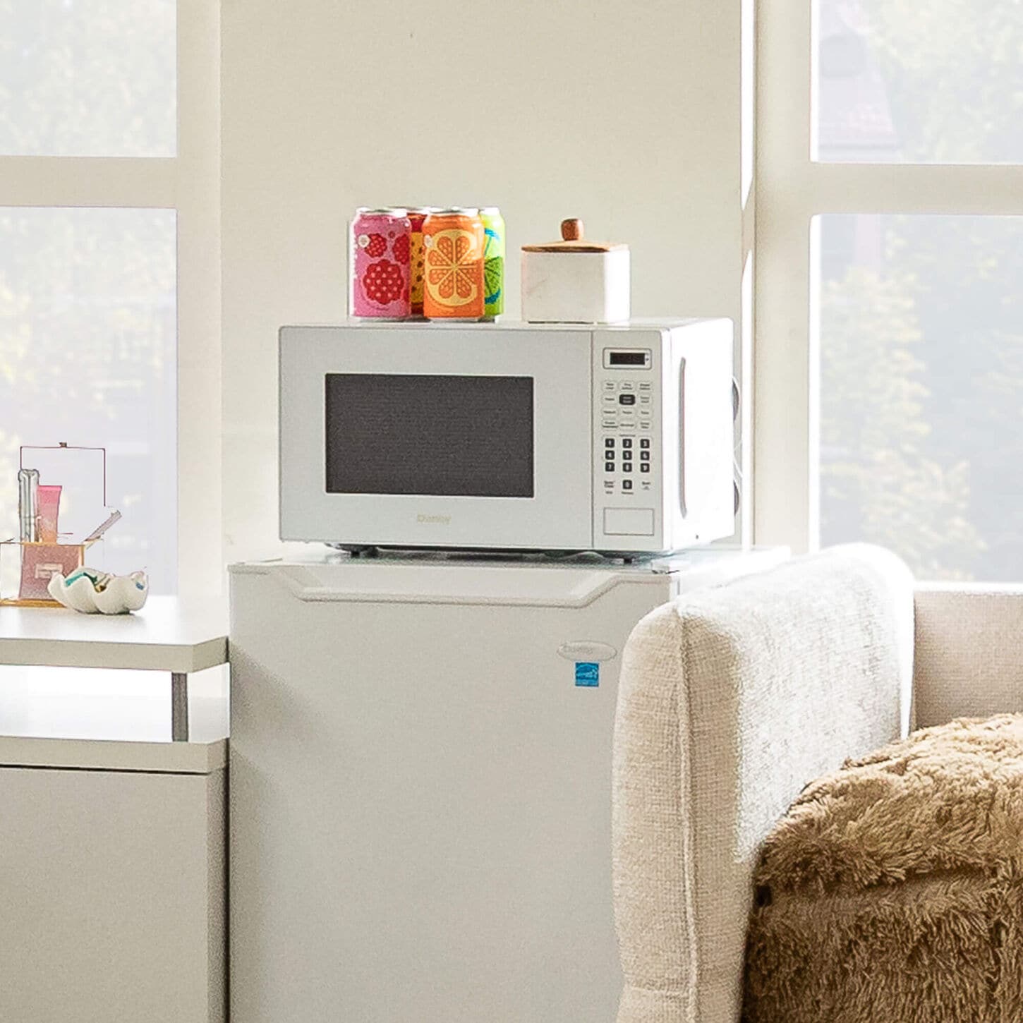 White microwave on top of fridge in dorm room