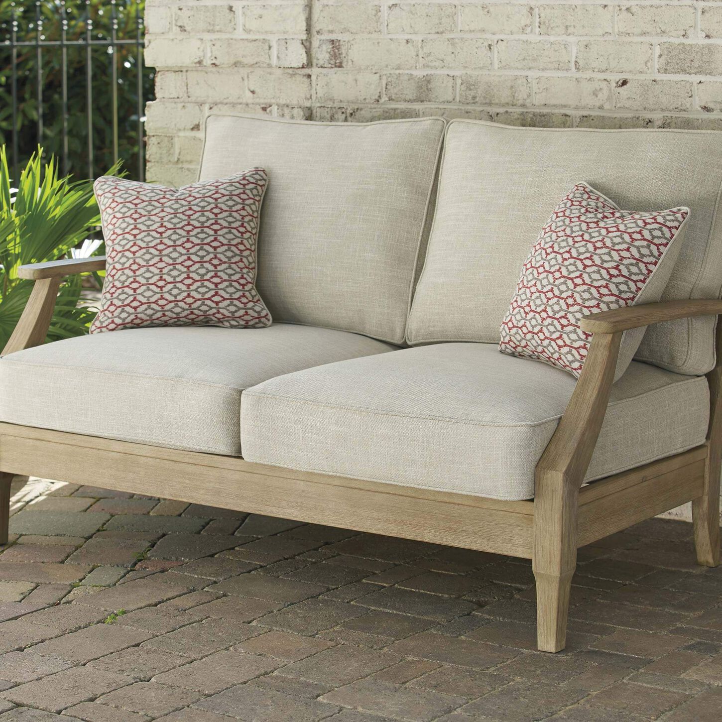 Ashley Clare View Loveseat with Beige Cushion in Antique Teak
