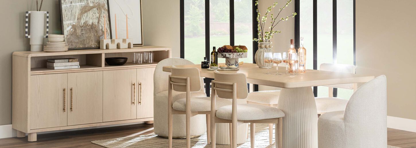 Dining room with neutral tone decor and wood buffet