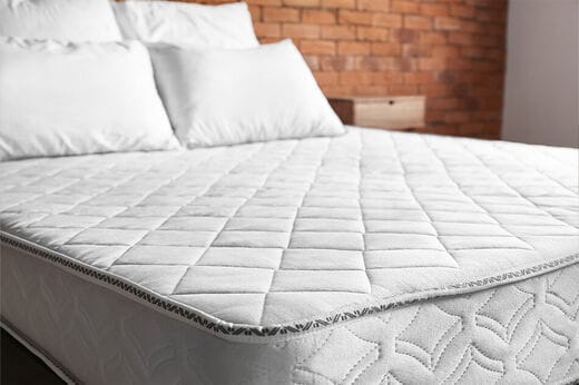 Bedroom with a very comfortable looking mattress and two pillows