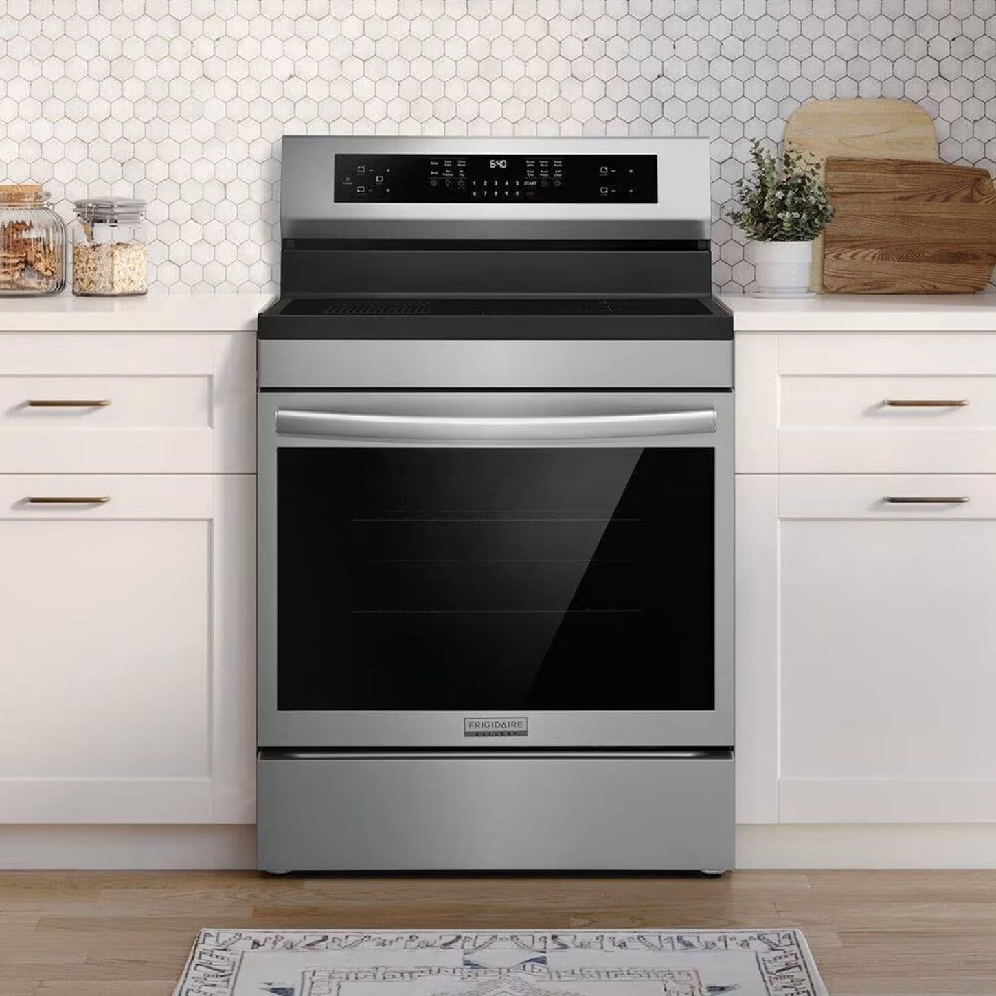 kitchen with white cabinets, a tile backsplash, and a stainless-steel range in the center of the cabinets