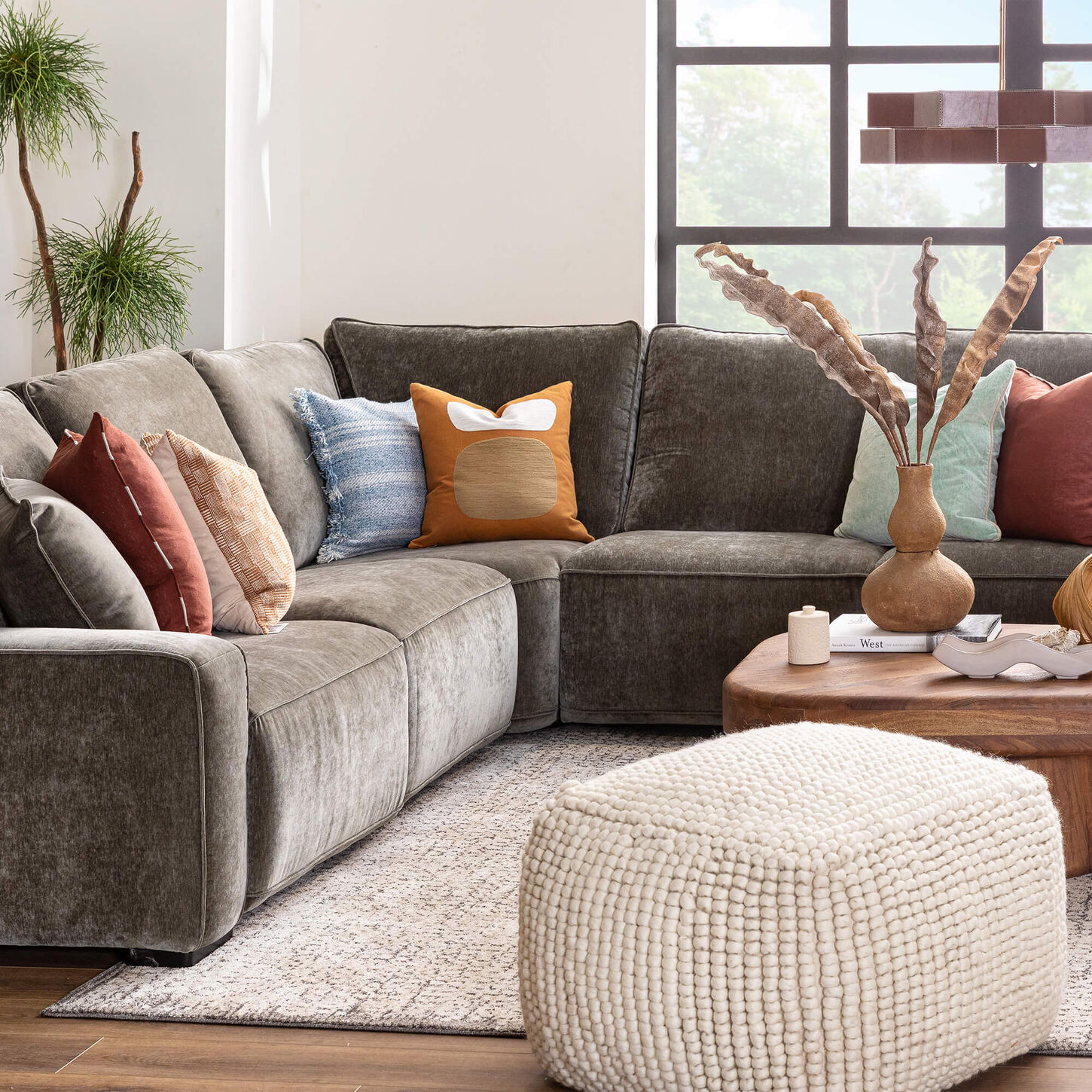 Man working on a laptop at a table with his cup of coffee