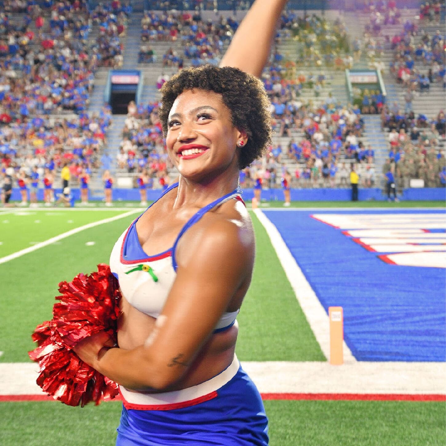 TyJanae cheering at a college football game in her uniform