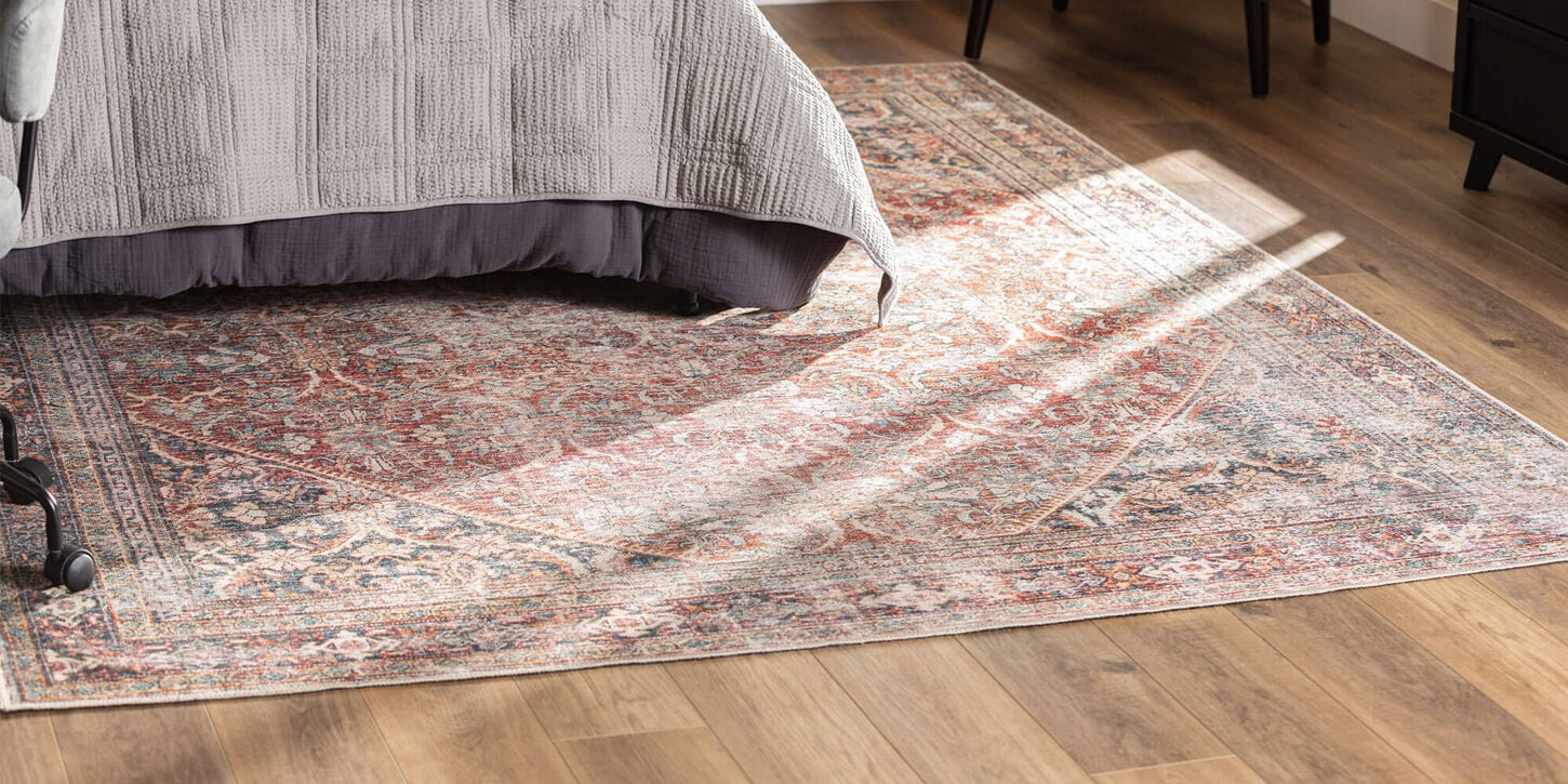 Multi-colored area rug in bedroom